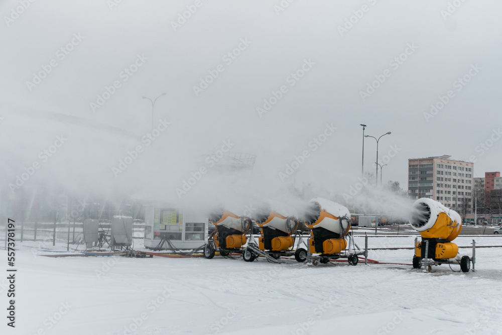 Snow cannons spray artificial snow crystals. Production of artificial snow. Snow guns. Cars make snow.