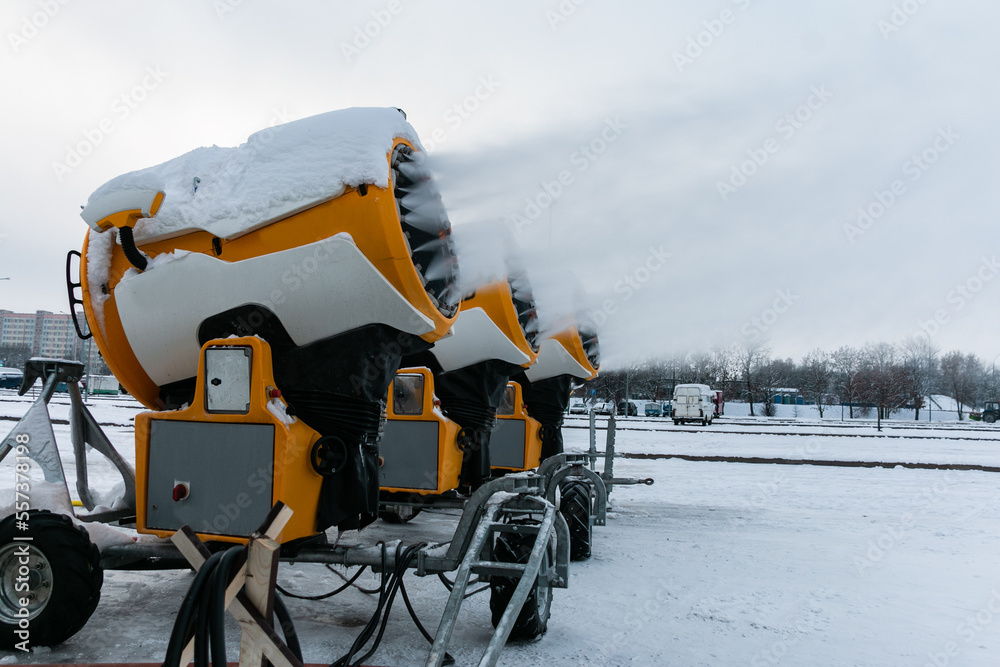 Snow cannons spray artificial snow crystals. Production of artificial snow. Cars make snow. Snow guns.