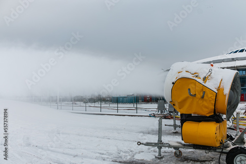 Obraz na płótnie Snow cannons spray artificial snow crystals. Production of artificial snow. Cars make snow. w salonie