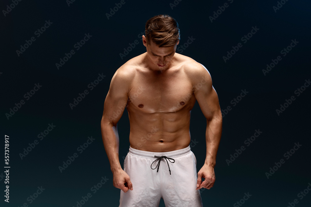 Fototapeta premium Photo of young handsome man enjoying his perfect body empty space