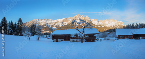 winter landscape tirolean alps with view to farmstead and Wilder Kaiser mountain photo