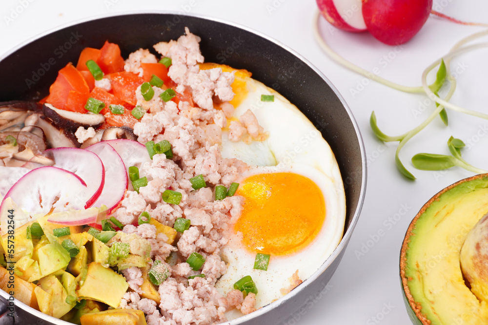Breakfast fried eggs in a pan on a white background Breakfast fried eggs in a pan on a white background