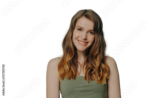 Positive joyful teen girl in top tank demonstrating optimism and happiness, isolated over blue wall © VK Studio