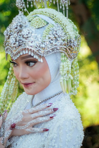 Amazing smiling wedding couple. Wedding day bride in wedding dress. Indonesian bride. Beautiful bride Beautiful bride and groom in outdoor.