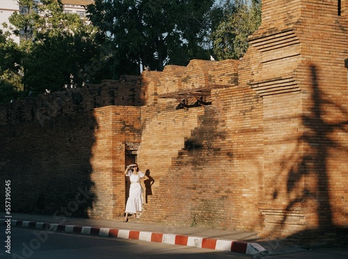 tourist girl on the stairs of the historic city gate, Pratu Tha Phae of chiang mai, thailand. photo