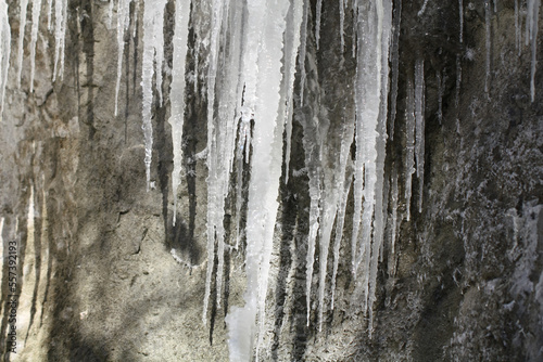 Icicles on the slope of the rock.