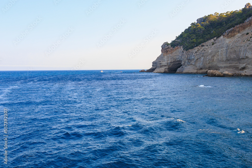 View of the rocky shore from the sea. Mediterranean Sea in Turkey. Popular tourist places. Background View of the rocky shore from the sea. Mediterranean Sea in Turkey. Popular tourist places. Background