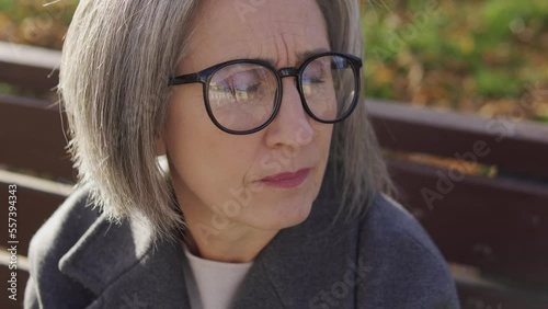 Offended senior woman waiting for man who did not come on a date, loneliness
