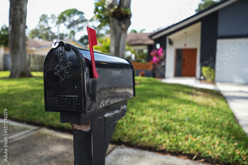 Black mailbox in front of a house