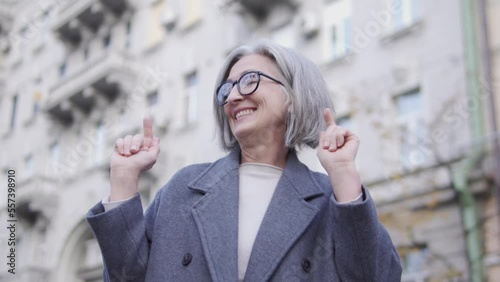Wallpaper Mural Extremely happy positive woman in her 60s actively moving standing outdoor, dancing to music, enjoying her life and success, freedom and positivity, celebrating Torontodigital.ca
