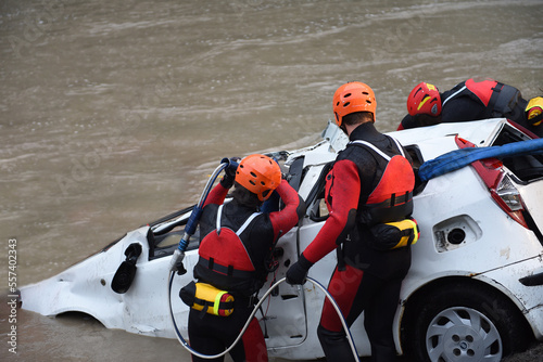 Firefighters and divers recover a driver's car that ended up in a lake or river after a terrible accident.