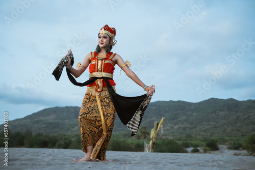 portrait young women presenting traditional Javanese dance movements photo