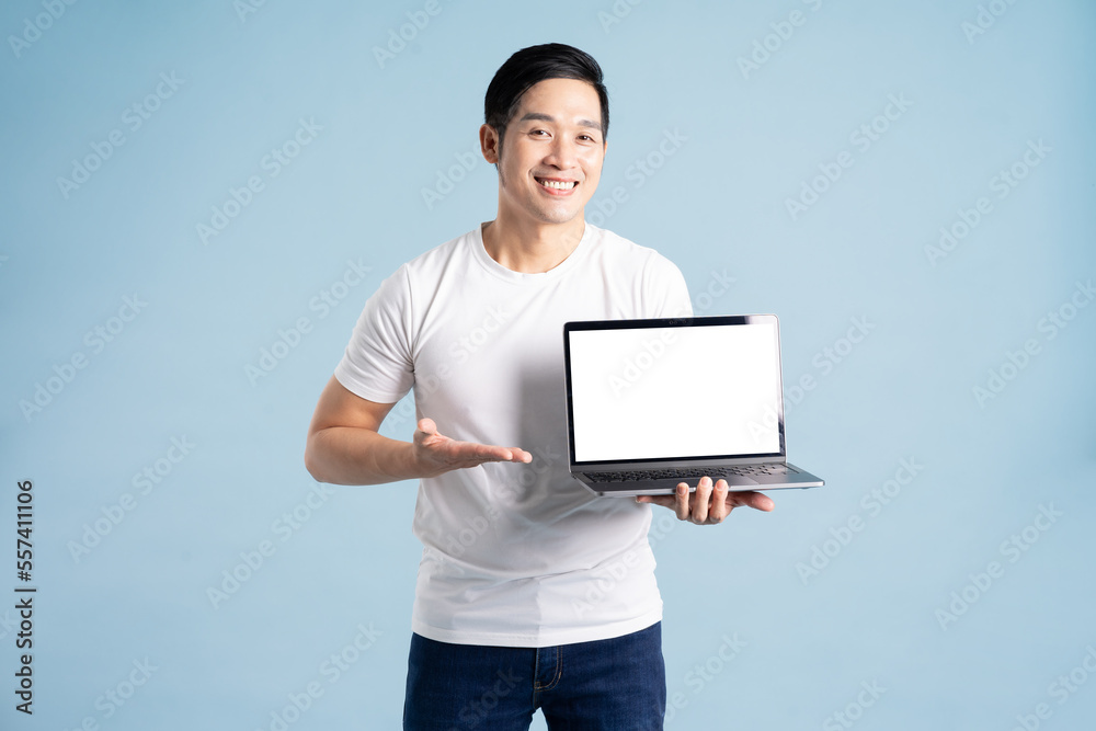portrait of asian man posing on blue background portrait of asian man posing on blue background