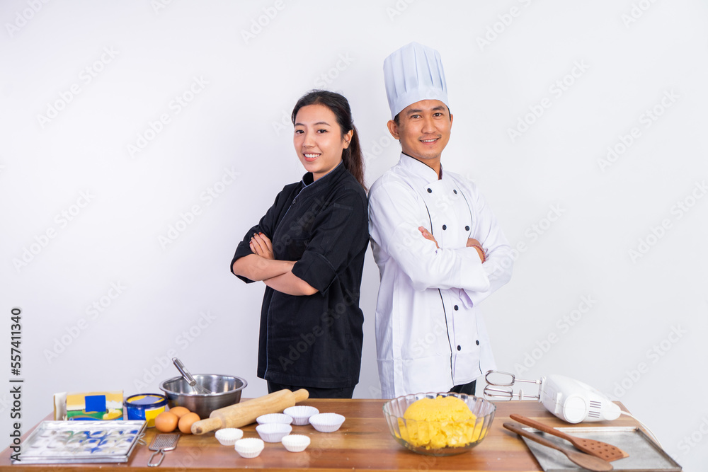 asian male and female chef standing with hands crossed on isolated background