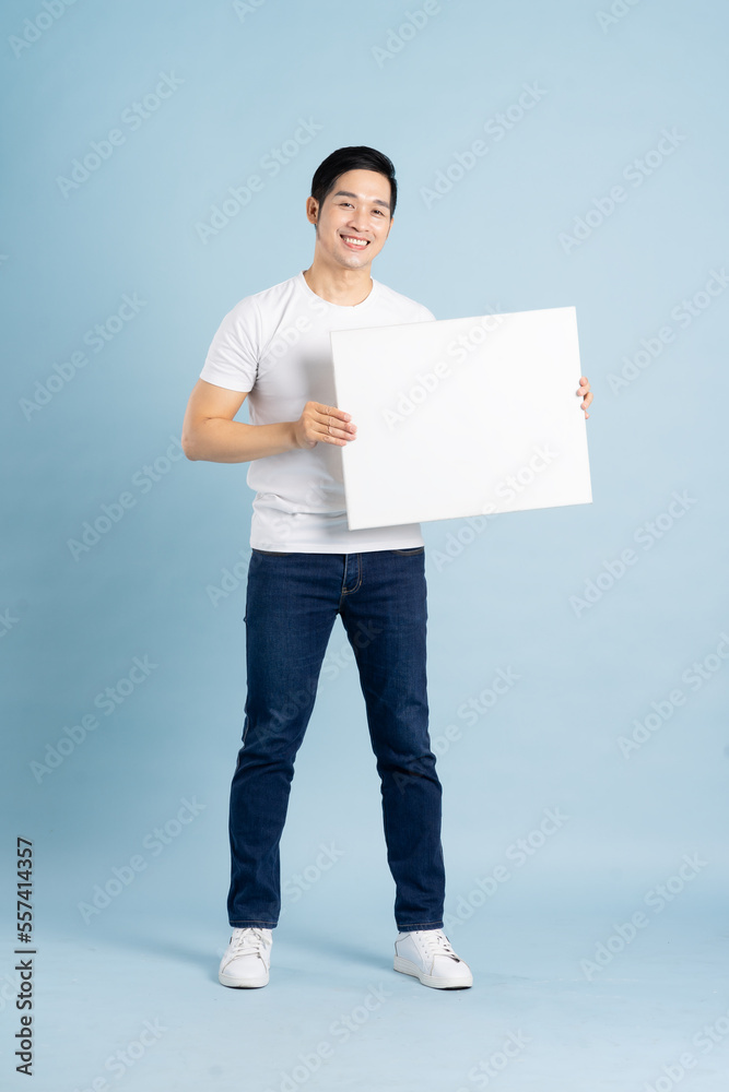 portrait of asian man posing on blue background portrait of asian man posing on blue background