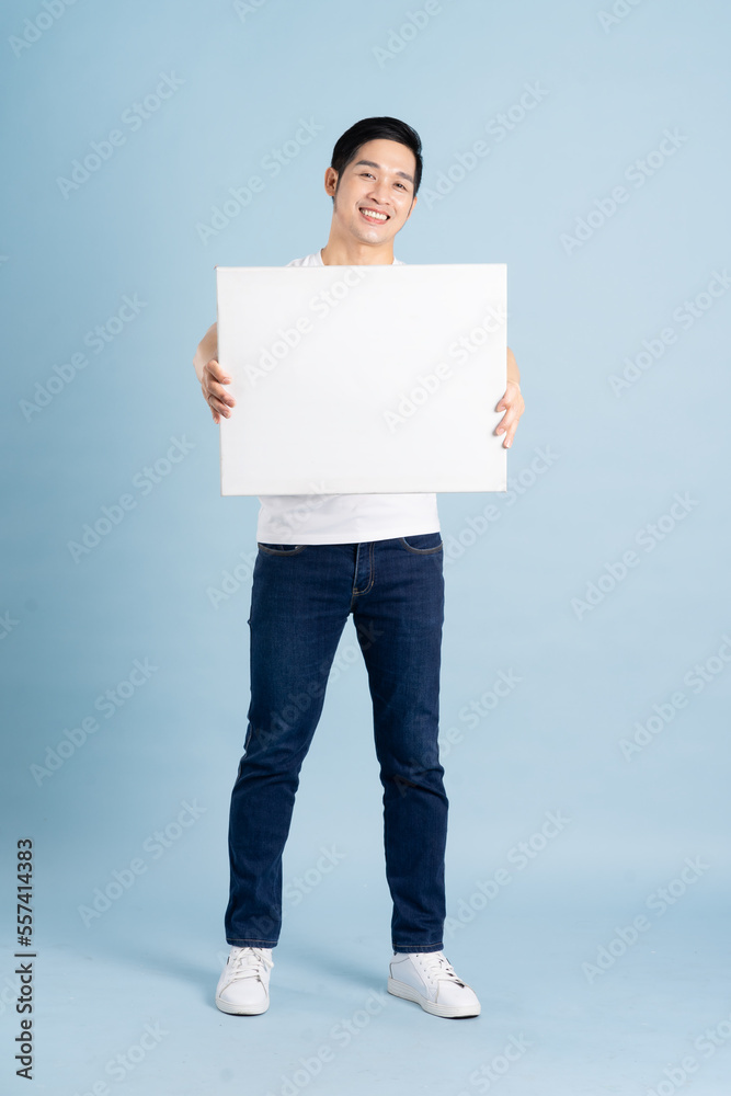 portrait of asian man posing on blue background portrait of asian man posing on blue background