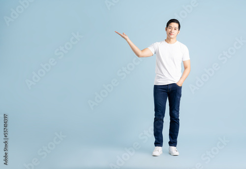 portrait of asian man posing on blue background