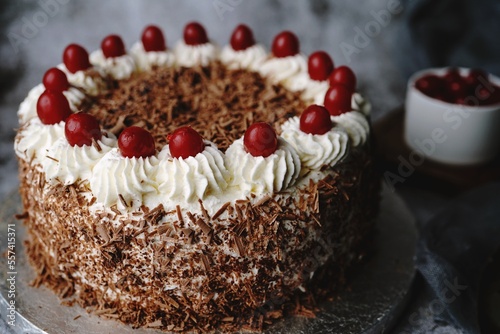 Homemade Black forest cake topped with fresh cherries, selective focus photo