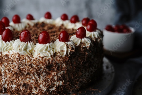 Homemade Black forest cake topped with fresh cherries, selective focus photo