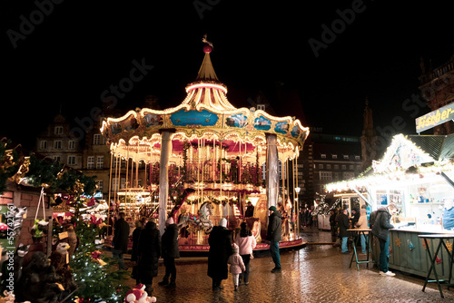 The Old City of Bremen during the holidays season, Christmas market in Bremen, Die Sögestrasse, street of Bremen with light reflexion after the rain, people in Xmas Market © Muhanad