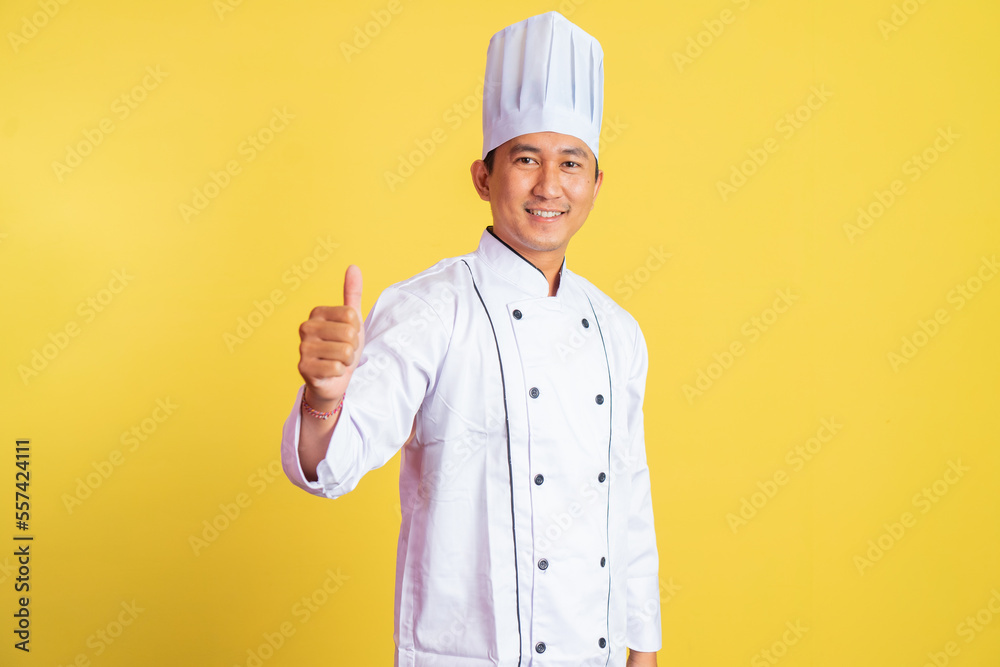 smiling asian male chef with thumbs up on isolated background smiling asian male chef with thumbs up on isolated background