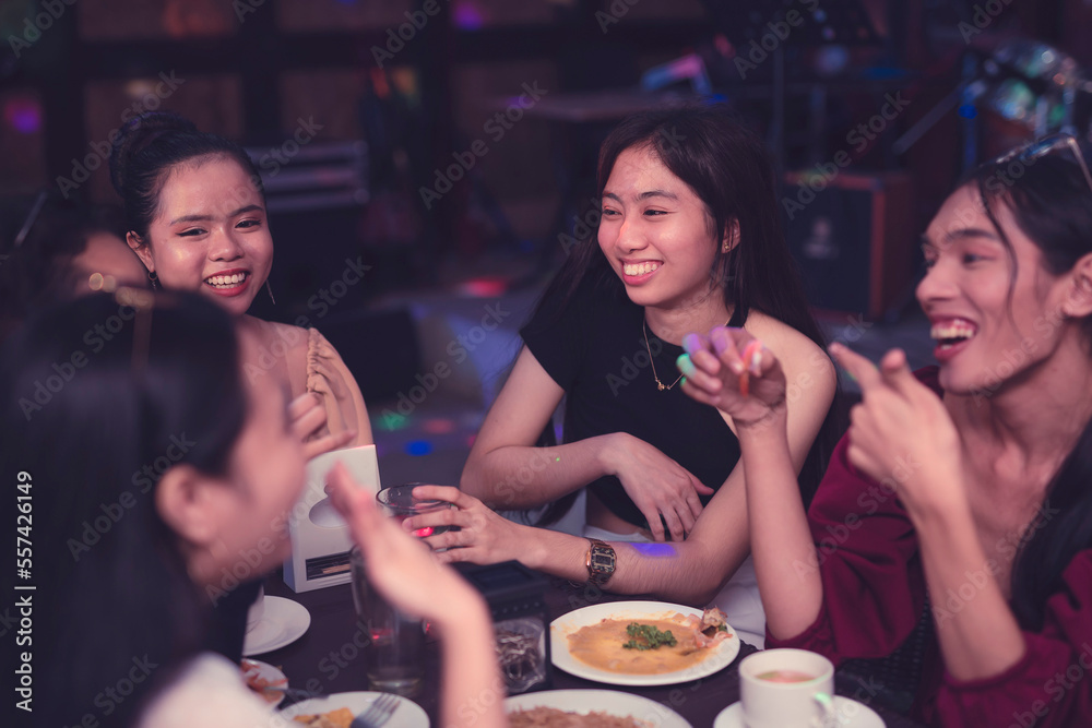 A candid shot of friends beaming at each other as they enjoy their meal while catching up. Friendship bonding concept.