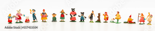 Banner panorama row of small vintage toy people and characters isolated on white