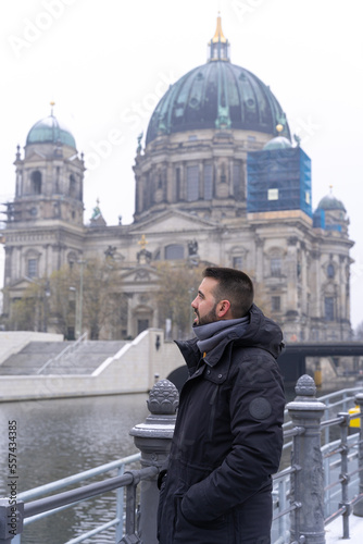 Young bearded male tourist, happily having his picture taken with the Berlin Cathedral in the background. © Jenni Ventura Martil