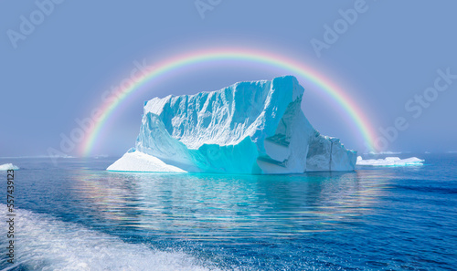 View of Greenland glaciers and iceberg from the village of Kulusuk in East Greenland - Kulusuk  Greenland - Melting of a iceberg and pouring water into the sea with amazing rainbow