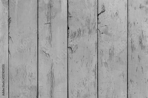 Texture of rural stained exterior vertical oak planks of country shed. Old dirty rough siding of gnarled surface wooden paneling. Rustic veined facing lumber fence of hard boards for 3D style design