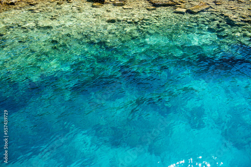 Azure ripples of shiny surface. Rippled shoal reflect of water.Heavy sea seashore depth for background. Sunny liquid smooth fine blink tide of seaside. Deep vivid blue vintage relax nice beach of swim