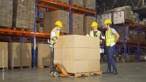 Teamwork of workers working in large warehouse retail store industry.Rack of stock storage. Interior of cargo in ecommerce and logistic concept. Depot. People lifestyle. Shipment service for container