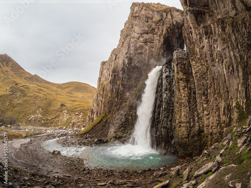 Autumn mountains in autumn morning. Gil-Su waterfall in wide autumn valley in North Caucasus, Russia. Beautiful landscape.