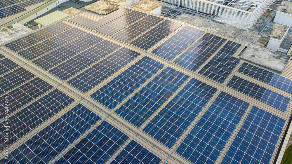 Aerial view of a solar panel photovoltaic with reflection on building roof top. Aerial view of a solar panel photovoltaic with reflection on building roof top.