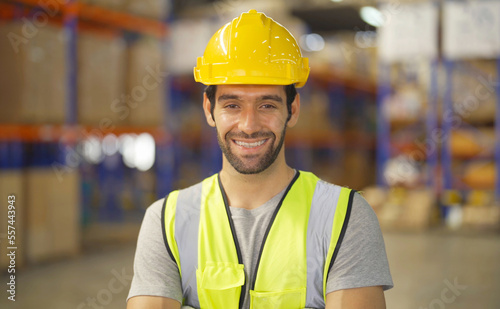 Portrait of middle east worker working in large warehouse store industry.Rack of stock storage. Interior of cargo in logistic concept. Depot. People lifestyle. Shipment service for container © tampatra