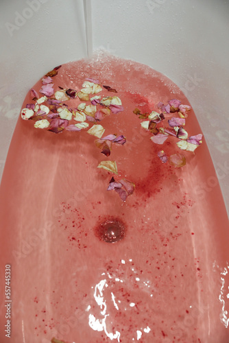 pink bath bomb and rose petals