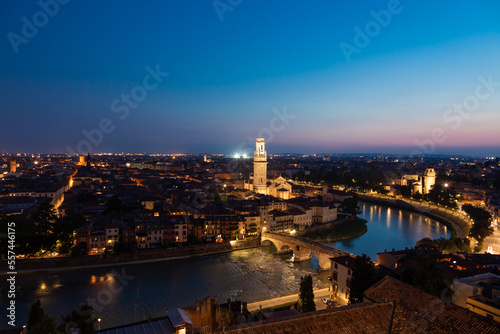 Verona, Italy - June 2022: panorama by night. Illuminated cityscape with scenic bridge.