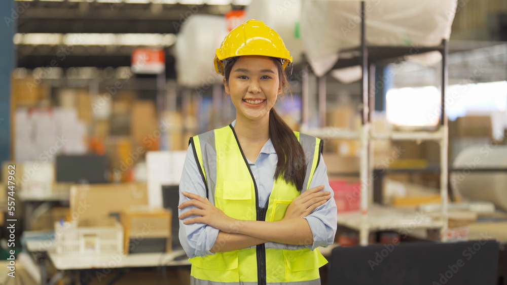 Portrait of Asian woman worker working in large warehouse retail store industry factory. Rack of stock storage. Cargo in ecommerce and logistic concept. Depot. People lifestyle. Shipment service. Portrait of Asian woman worker working in large warehouse retail store industry factory. Rack of stock storage. Cargo in ecommerce and logistic concept. Depot. People lifestyle. Shipment service.