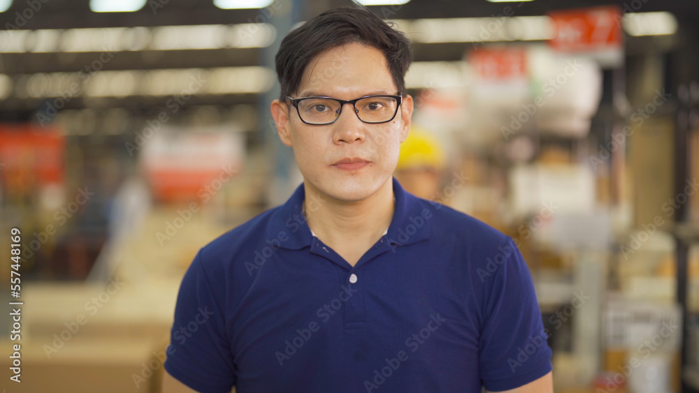 Portrait of Asian man worker working in large warehouse retail store industry factory. Rack of stock storage. Cargo in ecommerce and logistic concept. Depot. People lifestyle. Shipment service. Portrait of Asian man worker working in large warehouse retail store industry factory. Rack of stock storage. Cargo in ecommerce and logistic concept. Depot. People lifestyle. Shipment service.