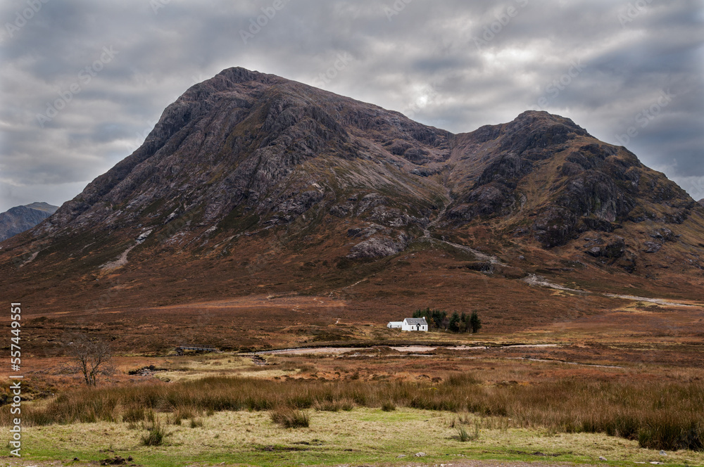 Buachaille Etive Mòr under a leaden sky  at the entrance to Glencoe with the iconic whitewashed cottage at its base