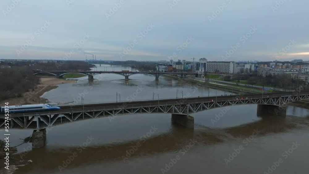 Fast train moving across Swietokrzyski Bridge over the Vistual river in Warsaw, Poland. European public transport in Poland. Fast train moving across Swietokrzyski Bridge over the Vistual river in Warsaw, Poland. European public transport in Poland.