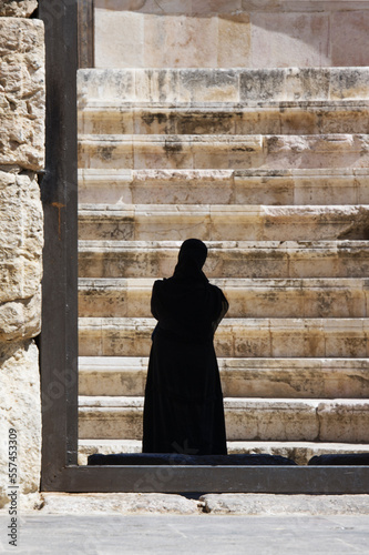 Woman in black burka in an arabic land photo
