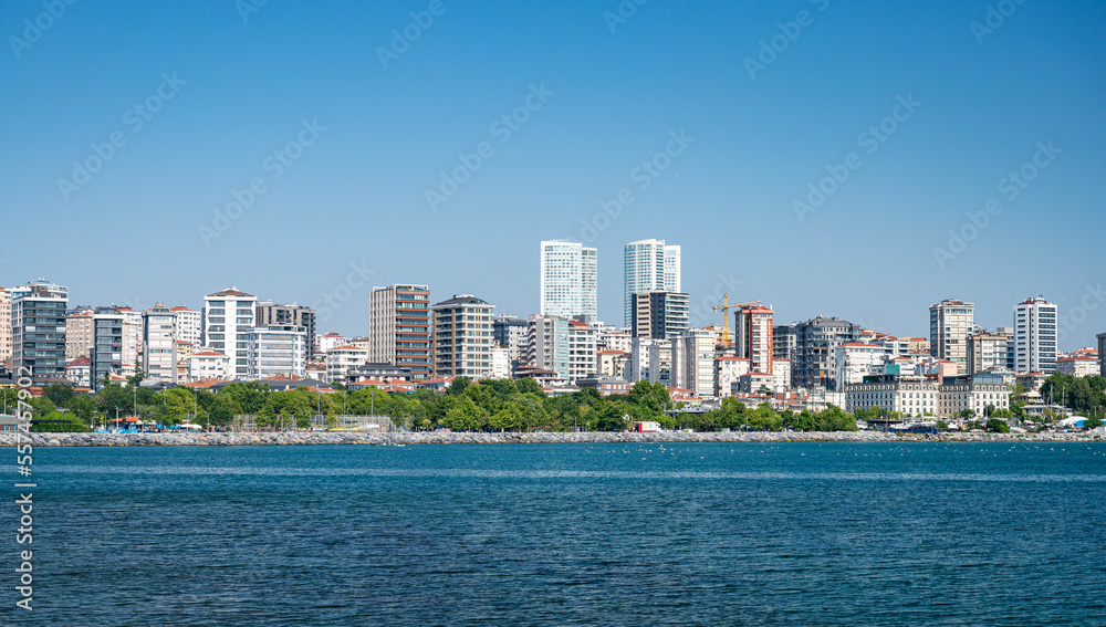 Fototapeta premium View from the sea to Istanbul. The coastline with new houses in the vicinity of the city. Summer panoramic landscape.