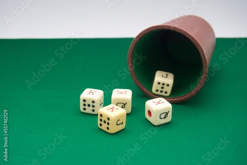 Poker dice game on green carpet 