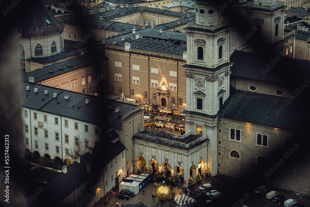 Naklejka premium Aerial shot of Christmas market in Domplatz, Salzburg, Austria, from Fortress Hohensalzburg at dusk - wide