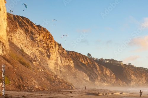Paragliders over the tops of coastal cliffs