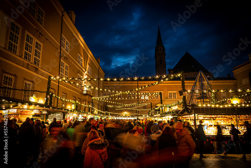 Busy Domplatz Christmas Market at night in Salzburg, Austria - Off center