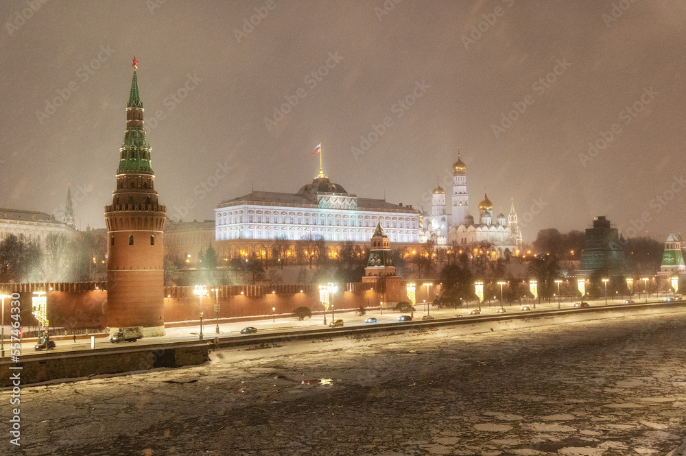 Moscow, Russia - December 27, 2022: Tower of the Moscow Kremlin. Cold and deserted Moscow street on a snowy winter evening near Red Square