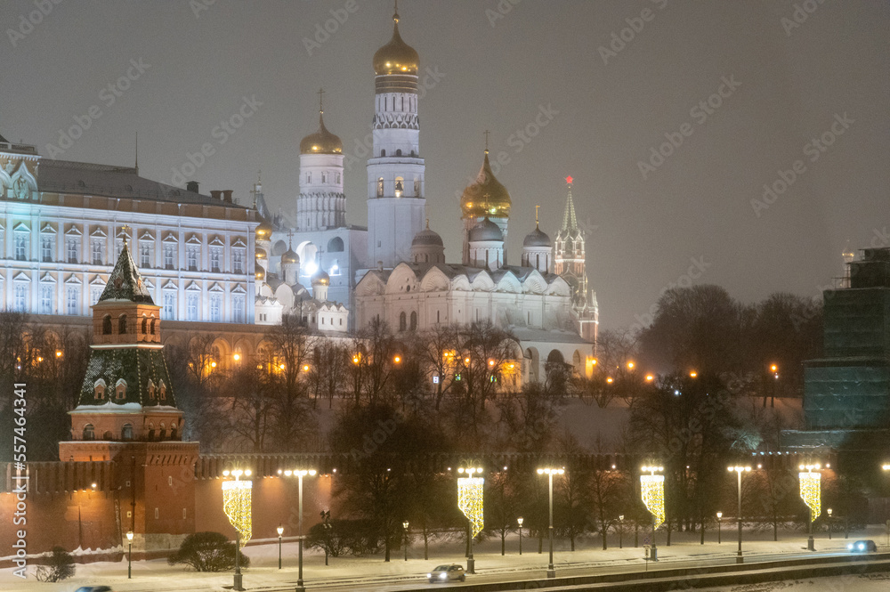 Moscow, Russia - December 27, 2022: Tower of the Moscow Kremlin. Cold and deserted Moscow street on a snowy winter evening near Red Square