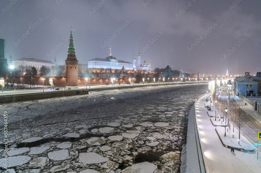 Moscow, Russia - December 27, 2022: Tower of the Moscow Kremlin. Cold and deserted Moscow street on a snowy winter evening near Red Square